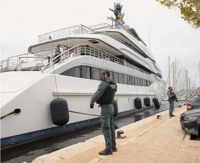  ?? Francisco Ubilla / Associated Press ?? Earlier this month, civil guards stood watch over a yacht in Mallorca, Spain, that is owned by a Russian oligarch. “Undermoney” dabbles in a Putin-esque plot, months before the Ukraine conflict.