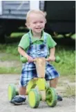  ??  ?? Gabriel enjoys showing off his toys to visitors and riding around in his trike.