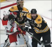  ?? CHARLES KRUPA - THE ASSOCIATED PRESS ?? Boston Bruins’ Zdeno Chara (33), of Slovakia, pushes Carolina Hurricanes’ Justin Williams (14) away from Bruins goalie Tuukka Rask during the first period in Game 2 of the NHL hockey Stanley Cup Eastern Conference final series, Sunday, May 12, 2019, in Boston.