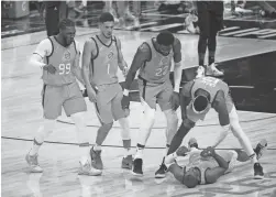  ?? PHOTOS BY MICHAEL CHOW/THE REPUBLIC ?? Suns guard Chris Paul, lying on court, celebrates with his teammates after making a 3-point basket after he was fouled against the Clippers during Game 6 at STAPLES Center Wednesday night.