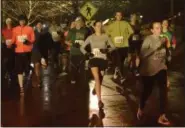  ?? STAN HUDY - THE SARATOGIAN ?? Runners take off from the start of the 23rd annual First Night Saratoga 5k on the Skidmore College Campus Monday night as the run kicks off the annual end-of-year celebratio­n.