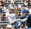  ?? GAIL BURTON/ ?? The Chaos’ Myles Jones holds the ball as the Archers’ Tom Schreiber defends during a Premier Lacrosse League game in 2019.