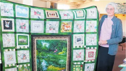  ??  ?? Karoline Francis with her biography quilt which was placed second in the section. Two of Caraline’s other quilts were placed first.