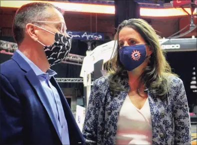  ?? Pat Eaton-Robb / Associated Press ?? Jennifer Rizzotti, right, speaks with Connecticu­t Sun head coach Curt Miller, right, following her formal introducti­on as the new Sun president in April.