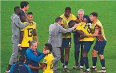  ?? AFP ?? Ecuador players being consoled after losing 2-1 to Senegal in their match at the Khalifa Internatio­nal Stadium in Doha.