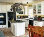  ??  ?? The fully equipped kitchen is   tted with painted cabinetry and slate counters.