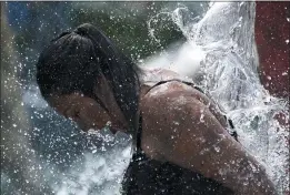  ?? NAM Y. HUH — THE ASSOCIATED PRESS ?? A woman cools off at a fountain in Mount Prospect, Ill., during Thursday’s heat. High temps across a vast area of the U.S. are expected to last into the weekend.