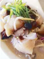  ??  ?? Sinuglaw is a hybrid of sinugba (grilled pork belly) and kinilaw (fish ceviche) using the hangsqueez­ed juices from tabon-tabon, local lime, and coconut vinegar with onions, ginger and chili.