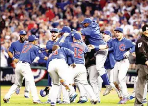  ??  ?? Chicago Cubs players celebrate after defeating the Cleveland Indians 8-7 in Game 7 to win their first World Series since 1908.