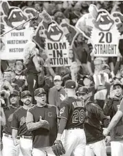  ?? Jason Miller / Getty Images ?? The party continues in Cleveland as the Indians and their fans enjoy the team’s 20th consecutiv­e victory.