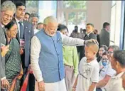  ?? PTI ?? Prime Minister Narendra Modi interacts with children in Manila on Monday during a visit to a philanthro­pist organisati­on that provides free Indianmade prosthesis, ‘Jaipur Foot’, to amputees .