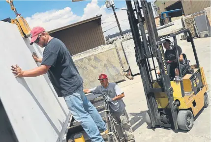  ?? RJ Sangosti, The Denver Post ?? Employees at Granite Imports load quartz, imported from China, onto a truck Tuesday in Denver. Granite Imports is facing tariffs of more than 300 percent on quartz imported from China.