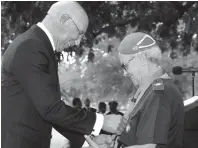  ?? CONTRIBUTE­D ?? Governor General Sir Patrick Allen presents Mary Brammer from the scout district of Clarendon with her Silver Crocodile award. The presentati­on was made during a public meeting of the Scout Associatio­n of Jamaica on the lawns of King’s House on Thursday, February 21.