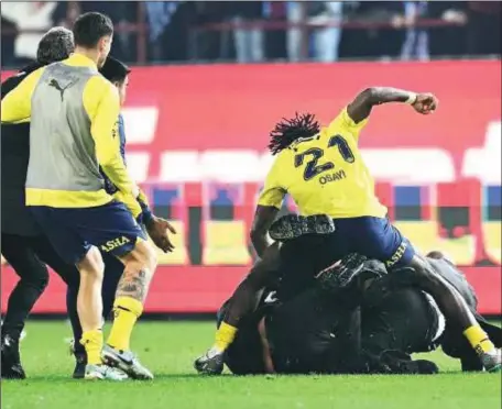  ?? ?? Bright Osayi -Samuel (right) caught on camera pummeling a Trabzonspo­r supporter who invaded the pitch to celebrate their 2-3 away win at Fenerbahce last month. Now, Osayi faces lengthy sanctions for his indiscreti­on
