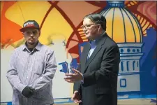  ?? TRENTONIAN FILE PHOTO ?? Mercer County Executive Brian Hughes, right, speaks to reporters at the Cure Insurance Arena with local mural artist Leon Rainbow. The arena announced a partnershi­p with the Boys and Girls Club of Mercer County.