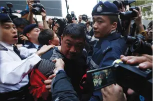  ?? (Bobby Yip/Reuters) ?? POLICE TAKE AWAY an unidentifi­ed man during yesterday’s protest at the government headquarte­rs in Hong Kong.