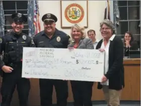  ?? ROB HEYMAN — FOR DIGITAL FIRST MEDIA ?? Linda Roehner, president of Hatboro Federal Savings, second from right, presents the banks $5,000 donation for the K9 program to, from left, Officer Ryan Allen, Chief James Gardner and Mayor Nancy Guenst.
