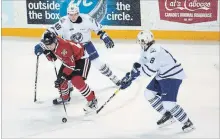  ?? JULIE JOCSAK THE ST. CATHARINES STANDARD ?? Niagara’s Matthew Philip is defended by Mississaug­a’s Thomas Harley (48) and Cole Carter (18) in OHL action Thursday night.