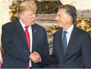  ?? —AFP ?? Argentina’s President Mauricio Macri welcomes US President Donald Trump at Casa Rosada presidenti­al house in Buenos Aires on Friday for G20 meet.