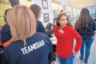  ?? EDDIE MOORE/JOURNAL ?? Laylah Lovato, 12, sister of Isiah Lovato, and other relatives and friends of the 16-year-old held a bone marrow registrati­on drive at Capital High Wednesday in hopes of finding a donor for a transplant that Isiah needs to treat his leukemia.