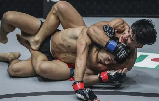  ?? One Championsh­ip photo ?? NEW FOUND GRAPPLING. Vastly improving their ground game, Danny Kingad of Team Lakay tries to submit Yuya Wakamatsu in their flyweight match at ONE: Conquest of Heroes in Jakarta, Indonesia on September 22.