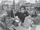  ?? WILFREDO LEE/AP FILE ?? Rosario Vargas bags groceries at the Presidente Supermarke­t in the Little Havana neighborho­od of Miami. Florida’s minimum wage will increase from $8.56 to $10 an hour in September.