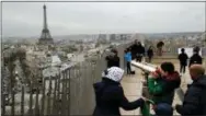  ?? CHRISTOPHE ENA — ASSOCIATED PRESS FILE PHOTO ?? In this March 21, 2017, file photo, tourists watch Paris from the top of the Arc de Triomphe in Paris, France. The Eiffel Tower is seen background.