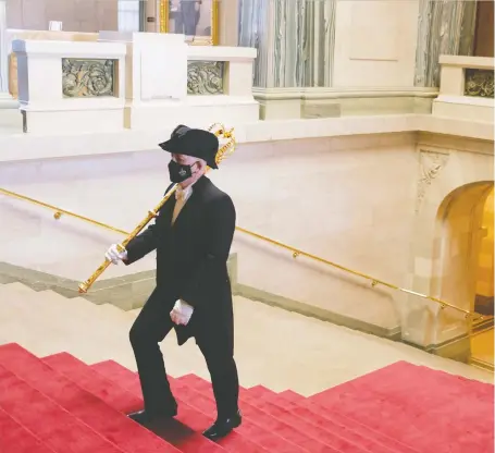  ?? MICHAEL BELL/ THE CANADIAN PRESS ?? Sergeant-at-arms Terry Quinn climbs stairs at the Legislativ­e Building in Regina ahead of the throne speech.