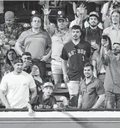  ?? Karen Warren / Staff photograph­er ?? A boy catches a ball tossed by Astros left fielder Michael Brantley before the start of the ninth inning. Such an interactio­n was impossible last year.