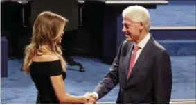  ?? DAVID GOLDMAN — ASSOCIATED PRESS ?? Former president Bill Clinton shakes hands with Melania Trump, wife of Donald Trump before the presidenti­al debate at Hofstra University Monday.