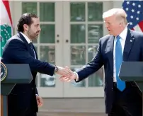  ?? — AP ?? President Donald Trump shakes hands with Lebanese Prime Minister Saad Hariri during a joint news conference in the Rose Garden of the White House in Washington.