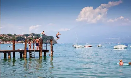  ?? Photograph: Tim Moore/Alamy ?? Children jumping into Lake Garda, northern Italy. Blue spaces have been found to be associated­with improvemen­t of mood and feelings of restoratio­n.