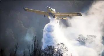  ?? WORKING ON FIRE ?? THE Vermaaklik­heid fire was contained after additional resources including 100 firefighte­rs from the Department of Environmen­tal Affairs, Working on Fire programmes as well as a Huey helicopter and two fixed wing air tractor 802 bombers were deployed. |