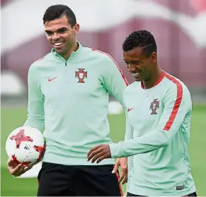  ?? — AFP ?? Sorry, mate: Pepe (left) made it into Portugal’s squad for the World Cup while teammate Nani was left out by coach Fernando Santos.