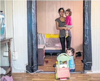  ??  ?? CAMP FOLLOWERS: Above, Selvida Ibrahimi with her epileptic daughter Nikolina and son Petar inside their container house at a makeshift camp in Belgrade.