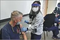  ??  ?? Ukiah ualley Fire Authority Capt. Skip villiams receives a Pfizer Covid-19 vaccine Thursday in Ukiah.