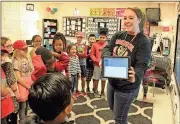  ?? Spencer Lahr / RN-T ?? East Central Elementary School third-grade teacher Heather Byington shows her students the app used to control Spheros, spherical robots, on Friday.