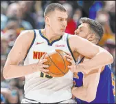  ?? David Zalubowski The Associated Press ?? Nuggets center Nikola Jokic powers past Knicks center Isaiah Hartenstei­n in Denver’s win Thursday at Ball Arena.