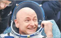  ??  ?? Scott Kelly reacts shortly after landing near the town of Dzhezkazga­n (Zhezkazgan), Kazakhstan, in file photo. — Reuters photo