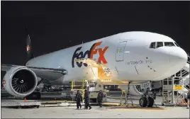  ?? LANCE MURPHEY/ REUTERS FILE ?? FedEx personnel finish unloading one of the company’s cargo planes during a nightly sort at the company’s Memphis, Tenn., hub.