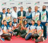 ??  ?? Mangalore University, overall champions in athletics at the Khelo India University Games, pose with the trophy in Bubaneshwa­r on Sunday.