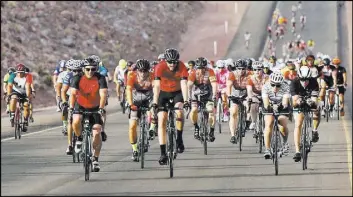  ??  ?? Cyclists ride on the yet-to-be-opened Interstate 11 in Boulder City on Saturday.