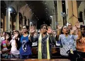  ?? TED ALJIBE/GETTY-AFP ?? Philippine Sen. Leila de Lima, center, prays with other Catholics during a Mass for victims of extrajudic­ial killings.