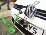  ??  ?? An electric Volkswagen car is plugged into a recharging point in central London, Britain November 10, 2016.