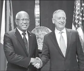  ?? EPA ?? Defense Secretary Delfin Lorenzana shakes hands with his US counterpar­t James Mattis after a bilateral meeting on the sidelines of the 17th Asia Security Summit in Singapore yesterday.