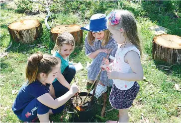  ??  ?? Lily Morris, Josie Monk, Beatrice Ethrington, and Ivy Chugg explore during the Littleseed­s program.