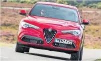  ?? ?? GAME ON Interior of Alfa Romeo Stelvio Sprint SUV has a leather-clad sports steering wheel and gear knob