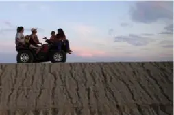  ?? GREGORY BULL/THE ASSOCIATED PRESS ?? A family rides their ATV in the drought-stricken community of Okieville, Calif.