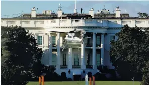  ??  ?? Donald Trump, the US president, and his wife, Melania, the first lady, have both tested positive for Covid-19. Below: a helicopter leaves the White House as Mr Trump is transferre­d to hospital for treatment