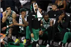  ?? ?? Boston Celtics guard Derrick White, center, stands in front of the bench as his teammates sit behind him in the closing seconds of the second half in Game 7 of the Eastern Conference Finals against the Miami Heat on Monday.